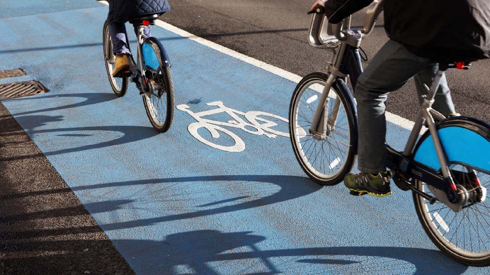 two cyclists in dedicated bike lane